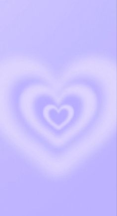 a heart shaped object in the middle of a blurry background with white and blue colors