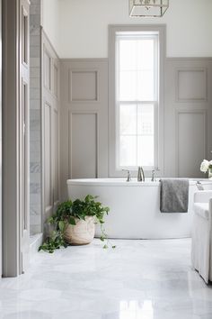 a white bath tub sitting next to a window