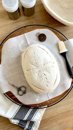 a wooden table topped with an uncooked dough on top of a white plate