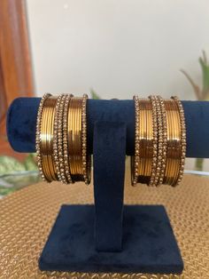 These Gold Plated  Detail Bangles make the perfect accessory for any occasion. With a set of two hand  bangles, you get to choose the perfect one to match your outfit. Crafted from Alloy and plated in gold, these bangles have a 2.6 size that is perfect for any wrist.  Features: - Set of bangles - Textured detail - Crafted from Alloy - Plated in gold - 2.6 size perfect for any wrist Metal Bangle Bracelets For Celebration, Adjustable Metal Bracelet For Celebration, Adjustable Metal Bracelets For Celebration, Metal Bangle Jewelry For Celebration, Metal Bangle For Celebrations, Festive Metal Bracelets For Parties, Metal Round Bangle For Party, Round Metal Bangle For Party, Adjustable Metal Bangle For Celebration