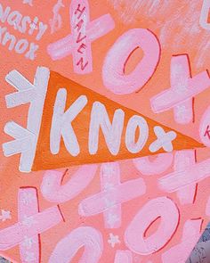 an orange and pink painting on the side of a building that says knox