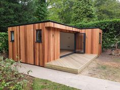 a small wooden shed sitting in the middle of a yard