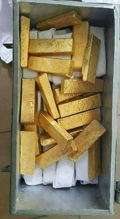 some gold bars are in a box on the floor