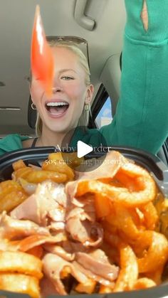 a woman sitting in the back seat of a car with food on top of it