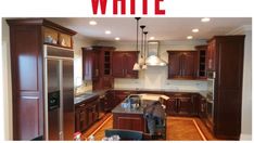 a kitchen with dark wood cabinets and white walls