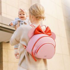 Details Pack up the magic today with our Disney Baby x FP Minnie Anaheim Backpack! This one of kind backpack is perfect for storing all the essentials for mom and baby. Disney Minnie's iconic ears are featured front and center, with small details this is a must-have for any Disney lover. With a spacious main compartment, front pocket, and 6 interior pockets, you can store everything you need for any adventure! Shop the entire Disney Baby x FP Collection here. Features Vegan saffiano leather 100% Minnie Mouse Travel Backpack, Minnie Mouse Backpack For Travel And Back To School, Minnie Mouse Backpack For Everyday Use, Playful Minnie Mouse Travel Bag, Minnie Mouse Everyday Backpack, Disney Minnie Mouse Backpack For Travel, Cute Minnie Mouse Backpack For Daily Use, Cute Minnie Mouse Backpack, Pink Minnie Mouse Backpack For Disney Trips