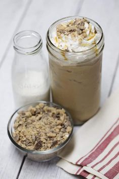 two mason jars filled with desserts on top of a table