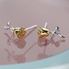 Enhance your everyday fine jewelry collection with these luxurious rose flower stud earrings. Crafted with solid 925 sterling silver, gold plating, and platinum plating, these earrings exude a high-end look and long-lasting shine. Perfect as a gift for a loved one or a romantic addition to your own collection. Brighten up your jewelry selection with these exquisite rose flower stud earrings. Made with top-quality materials like solid 925 sterling silver, gold plating, and platinum plating, these earrings radiate an elegant appearance and enduring brilliance. A thoughtful present for someone special or a charming touch to elevate your personal style. Material: 925 sterling silverFinish: gold platedDimensions: 0.47 x 0.15 in Jewelry Care: See more information about how to care for your jewel Rose Gold Flower Earrings With Roses, Elegant Rose Gold Earrings With Roses, Elegant Silver Flower Earrings Tarnish Resistant, Sterling Silver Rose Design Flower Earrings, Sterling Silver Flower Earrings With Rose Design, Sterling Silver Rose Gold Jewelry With Roses, Elegant Silver Tarnish Resistant Flower Earrings, Rose Gold Sterling Silver Jewelry With Roses, Elegant Rose Sterling Silver Earrings