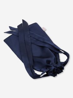 Piped in a complementary navy, the inside is gently padded for a soft and comforting feel, whilst a matching elasticated navy silk strap ensures a secure fit without being constricting on the skin. No more waking up wondering where your mask has disappeared to. Crafted by hand in our workshop in Cheshire, England from the finest pure navy Italian silk, our eye mask is so soft it instantly reassures you and envelops and provides a heavenly protective cocoon from the world. The eye mask also comes Cheshire England, Nighttime Routine, Silk Eye Mask, Suede Slippers, Satin Roses, Luxury Silk, Drawstring Pouch, Final Touch, Monogrammed Items