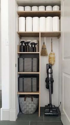 the shelves in this bathroom are filled with cleaning supplies