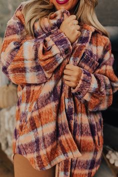 - Raise a toast to cozy season in this warm jacket! - Unlined material with a rust, blue, and purple hued plaid - A collared neckline - A button-up front - Long, loose sleeves - Functional chest pockets as well as side pockets - A relaxed silhouette that ends in a rounded hemline Plus Size Plaid, Collared Jacket, Button Up Jacket, Cozy Season, Loose Sleeves, Fall Favorites, Warm Jacket, Purple Hues, Plaid Tops