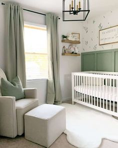 a baby's room with a white crib and green drapes on the window