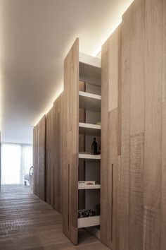 an empty room with wooden cabinets and shelves