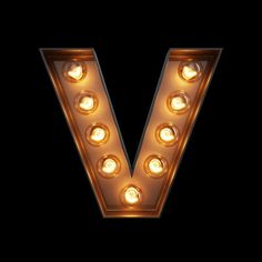 the letter v is lit up with light bulbs