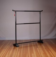 a bike rack sitting on top of a hard wood floor next to a white wall