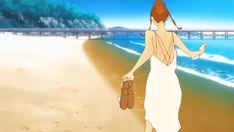 a woman is walking on the beach with her purse