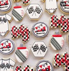 decorated cookies are arranged in the shape of cars and race outfits, along with other decorations