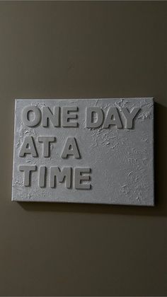 one day at a time sign on the wall