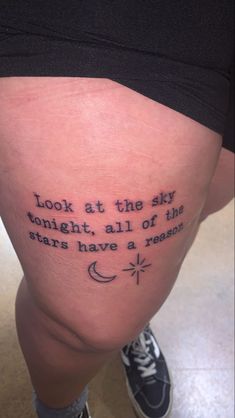 a person with a tattoo on their leg that says look at the sky tonight, all of the stars have a reason