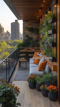 the balcony is filled with potted plants and flowers, along with an outdoor seating area