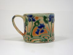 a ceramic mug with blue flowers on it