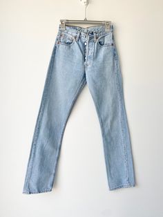 "Vintage Levi's 501  w25\" L31\" 1999 Spain   Light blue stone wash denim  Follow me on Instagram for new listing  Deuxieme loved Denim  100% Cotton no stretch. Please make sure size is good for you as no returns.  please read measurements before buying and ask any questions no returns Measurements taken laying flat.  Some stitch near buttons but doesn't affect the jeans just visible and noted.  Waist 32cm/12.5\" across flat (25\"total)  Crotch to waist 26cm 10.2\" Hips 49.5cm\" across flat 19.4\" total 38.9\"  Thigh across flat 26.5cm/10.4\" across  inside leg from crotch 79cm 31.1\" Ankle 18cm/6.6\" across flat  The tag is w25 L30 but please use measurements below not the tag.  If you have a pair of vintage levis compare measurements to get the best fit. Also always happy to help if you Levis Vintage, Jean Vintage, Vintage Levis 501, Levi’s 501, Levi's 501, Levis 501, Vintage Lighting, Vintage Jeans, Vintage Levis