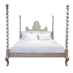 a white bed with four posts and pillows on it's headboard, in front of a white background