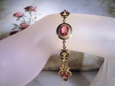 "This is a beautiful rose pink bracelet that is 14k Gold Filled. There are 4 oval cut faceted rosy pink glass gems with a decorative scroll link in between each. The look is stunning! Size of the bracelet is 7.25 inches. It has a round twist closure and a safety chain that is also able to be released and attached with the same type of closure. *Hang Tag reads: AMCO, 1/20 14K Gold Filled *Length is 7.25 inches *Width is .5 inches *Condition is Excellent = in \"LIKE NEW\" Condition; Pre-owned To v Pink Gold Formal Fine Jewelry Bracelets, Pink Bangle For Formal Occasions, Pink Formal Bangle Jewelry, Elegant Rose Gold Bracelet For Formal Occasions, Pink Gold Formal Bangle Jewelry, Antique Hallmarked Pink Jewelry, Elegant Pink Gold Bracelet For Formal Occasions, Antique Pink Round Jewelry, Pink Jeweled Jewelry For Formal Occasions