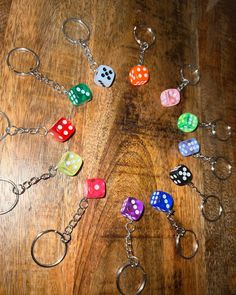 several dice shaped key chains on a wooden table