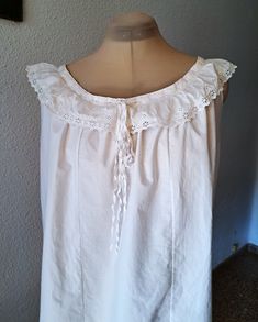 Very beautiful off white cotton victorian camisole top, sleeveless with   floral lace at the  neck, has cord are adjustable the neckline. It is made with very care, the hems of the sleeves and the bottom are made by hand. Very good vintage condition Measurements taken flat: armpit to armpit - 55 cm/ 21.8'' bottom width - 67 cm/ 26.5'' length - 55 cm/ 21.8'' approximate size -  L - XL Vintage Sleeveless Cotton Camisole, Sleeveless Tops With Delicate Lace For Daywear, Cotton Sleeveless Camisole With Delicate Lace, Sleeveless Cotton Camisole With Lace, Cotton Tops With Lace Trim Sleeveless Blouse, Sleeveless Cotton Lace Top With Delicate Detail, Vintage White Camisole For Daywear, White Vintage Camisole For Daily Wear, Sleeveless Cotton Top With Lace Collar