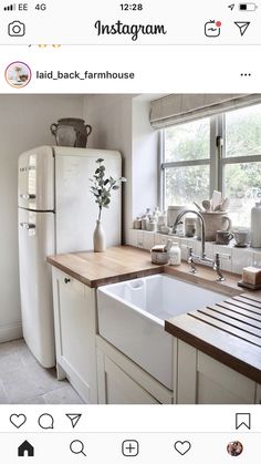 a kitchen with a sink, refrigerator and window