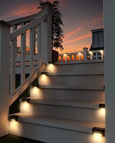 some lights that are on the side of a set of stairs