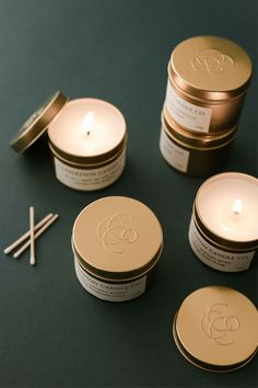 three candles and two tins on a table