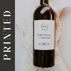 a bottle of wine sitting on top of a white blanket