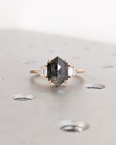 a black diamond ring sitting on top of a table