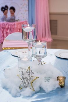 the table is set with candles and decorations for a special occasion in pink, white and gold