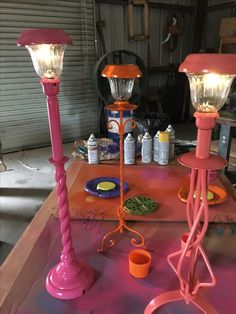 two pink lamps sitting on top of a table