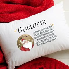 a santa clause pillow on top of a red blanket