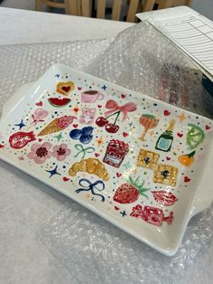 a white plate topped with lots of colorful stickers