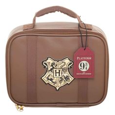 a brown harry potter suitcase with hogwart's crest on the front and hogwarts crest on the back