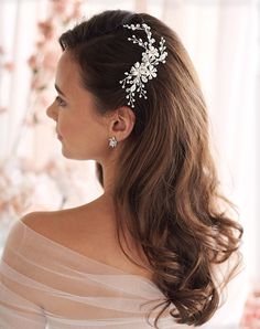 a woman wearing a hair comb with flowers on it