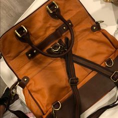 Can Be Worn So Many Different Ways. It’s Real Leather, Bought In Italy. Never Used Brand New Conditions. Smells Like Perfect Leather. When Opened On The Biggest For Fits A Laptop 15 Inch Perfectly Color Is Like A Rustic Orange With Brown Designer Travel Shoulder Bag With Leather Backing, Designer Brown Leather Rectangular Backpack, Luxury Brown Leather Backpack With Detachable Strap, Designer Brown Leather Backpack For Daily Use, Orange Office Satchel With Detachable Strap, Leather Backpack With Detachable Strap For Shopping, Designer Leather Backpack For Shopping, Orange Top Handle Bag For Office, Orange Top Handle Office Bag