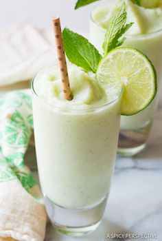 two glasses filled with ice cream and lime slices