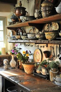 an old fashioned kitchen with lots of pots and pans