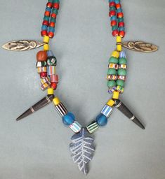 This necklace with glass beads and different amulet pendants originates from Nepal. The hanging length of the strand is 30 cm. The diameter of the beads is 0.7 cm to 1.5 cm. The pendants are 2 cm to 5.5 cm long. Its weight is 145 gram. (e7) SHIPPING SHIPMENT is FREE. All items are shipped within two working days after receipt of payment. We send everything by registered airmail. Insured packets (over 50 cm length / over 1500 gram) I send by standard way. PAYMENT Paypal is preferred. RETURN POLIC Colorful Beads Amulet Pendant Necklace, Multicolor Beaded Amulet Necklaces, Multicolor Beaded Amulet Jewelry, Adjustable Brown Beaded Amulet Necklace, Brown Beaded Amulet-style Jewelry, Relief Sculpture, Resin Beads, Star Necklace, Metal Sculpture