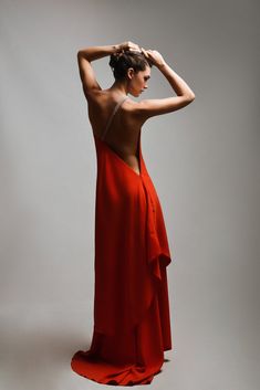 A mesmerizing red dress that embodies both allure and sophistication, showcasing a daring open-back design that adds a touch of sensuality. The focal point of this stunning ensemble is a meticulously crafted belt, adorned with hand-sewn stones, accentuating the shoulder and the back with a dazzling display of shimmer. The rich red hue of the dress exudes confidence and passion, while the intricately embellished belt elevates the glamour quotient. Together, the open back and the bedazzled belt cr Maxi Dress With Closed Back For Evening, Maxi Dress With Back Opening For Evening, Red Backless Evening Dress With Back Opening, Low Back Maxi Evening Dress With Opening, Red Sleeveless Backless Dress, Red Sleeveless Backless Dress With Back Opening, Low Back Maxi Dress With Back Opening For Evening, Evening Dresses With Low Back And Back Opening, Low Back Evening Dresses With Back Opening