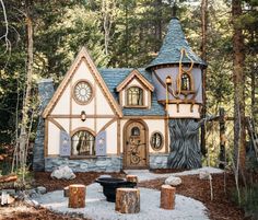 a small house in the woods with a clock on it