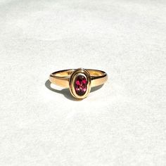 Here is one of my favorite all-time rings.  It is a very beautiful, one of a kind, 14k gold ring, featuring a smashing warm pink spinel oval cut stone. This marvelous, well cut lively stone is from Myanmar. It is 0.54ct carat.  It is bezel set, and open back. The shank is a simple and sturdy rounded gold strip. This is a wonderful fantasy ring! This ring is size 7 1/2 Thank you for looking! Classic Oval Tourmaline Jewelry, Oval Tourmaline Solitaire Jewelry, Oval Solitaire Tourmaline Jewelry, Oval Topaz Ring In 14k Gold, Oval Ruby Ring In 14k Gold, 14k Gold Oval Birthstone Ring, 14k Gold Oval Ruby Ring With Center Stone, Heirloom 14k Gold Oval Ruby Ring, Heirloom Oval Ruby Ring In 14k Gold