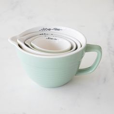 These charming measuring cups are inspired by vintage batter bowls. Perfect for your cooking needs, the inside of each of these measuring cups is marked in both ounces and cups. One side of each is designed with a V-shaped spout for easy pouring. They stack inside each other for easy storing and are dishwasher safe. Dimensions: 4.3" x 4.0" Kitchen Equipment Storage, Measuring Cups Set, Batter Bowl, Paper Table, Equipment Storage, Vintage Silverplate, Cups Set, Bar Glassware, Vase Candle Holder