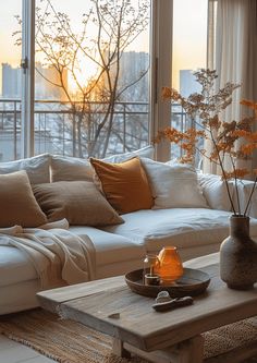 a living room filled with furniture and a large window covered in windowsills next to a white couch